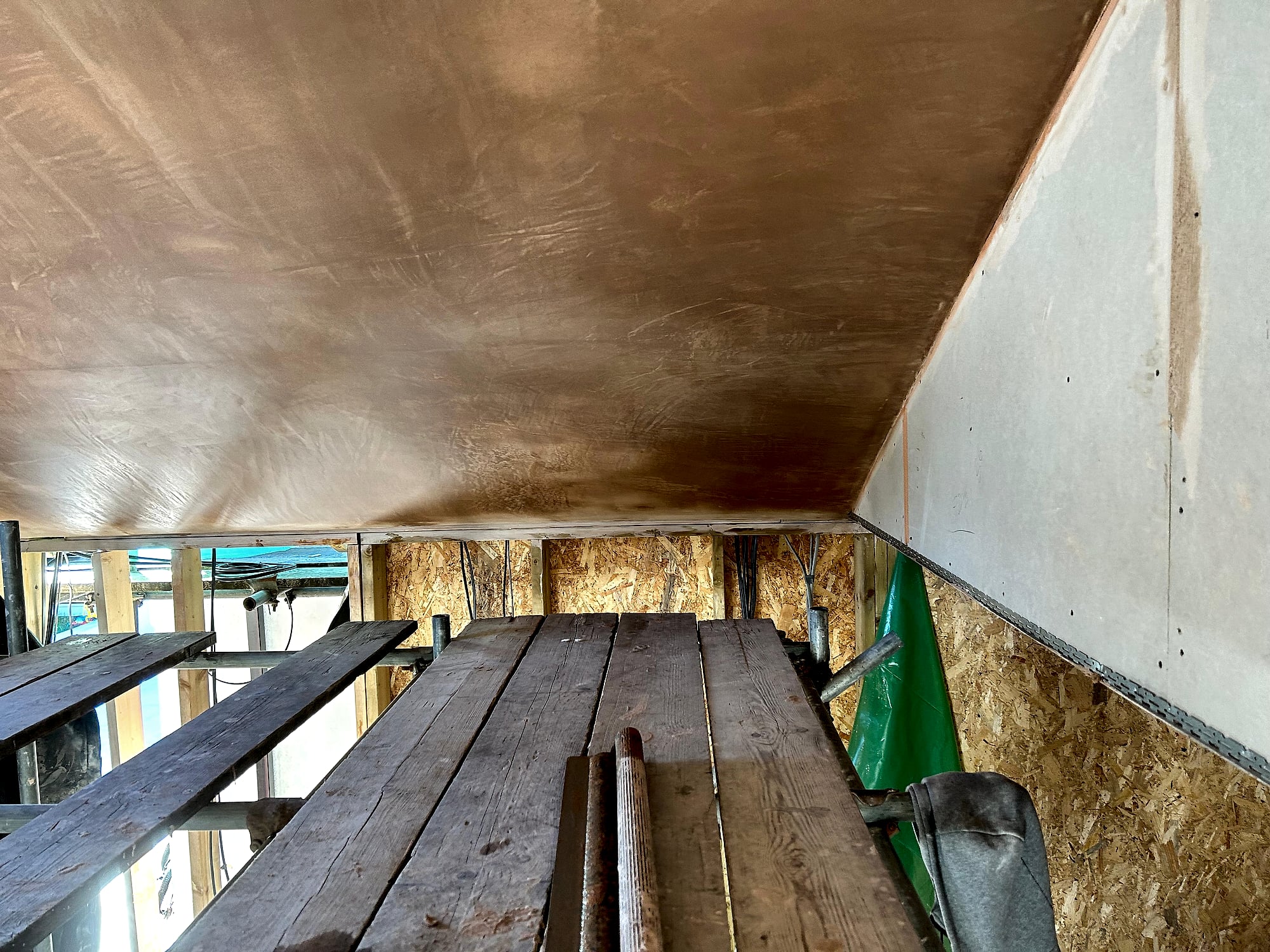 Apex ceiling ridge detail with fresh skim coat on both slopes of vaulted ceiling in Kent extension
