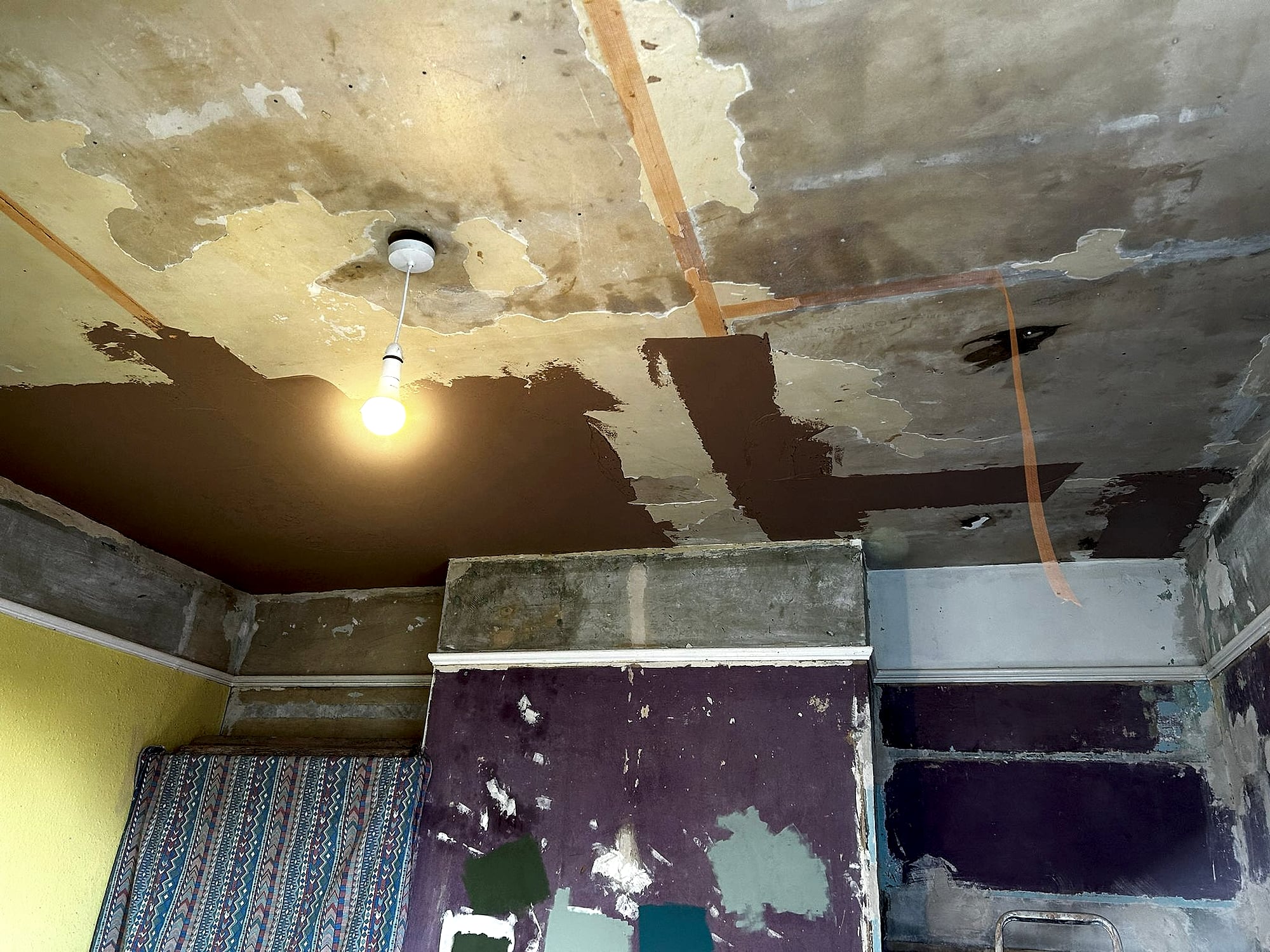 Bedroom ceiling before plastering showing severe water damage and peeling plaster in Kent period property