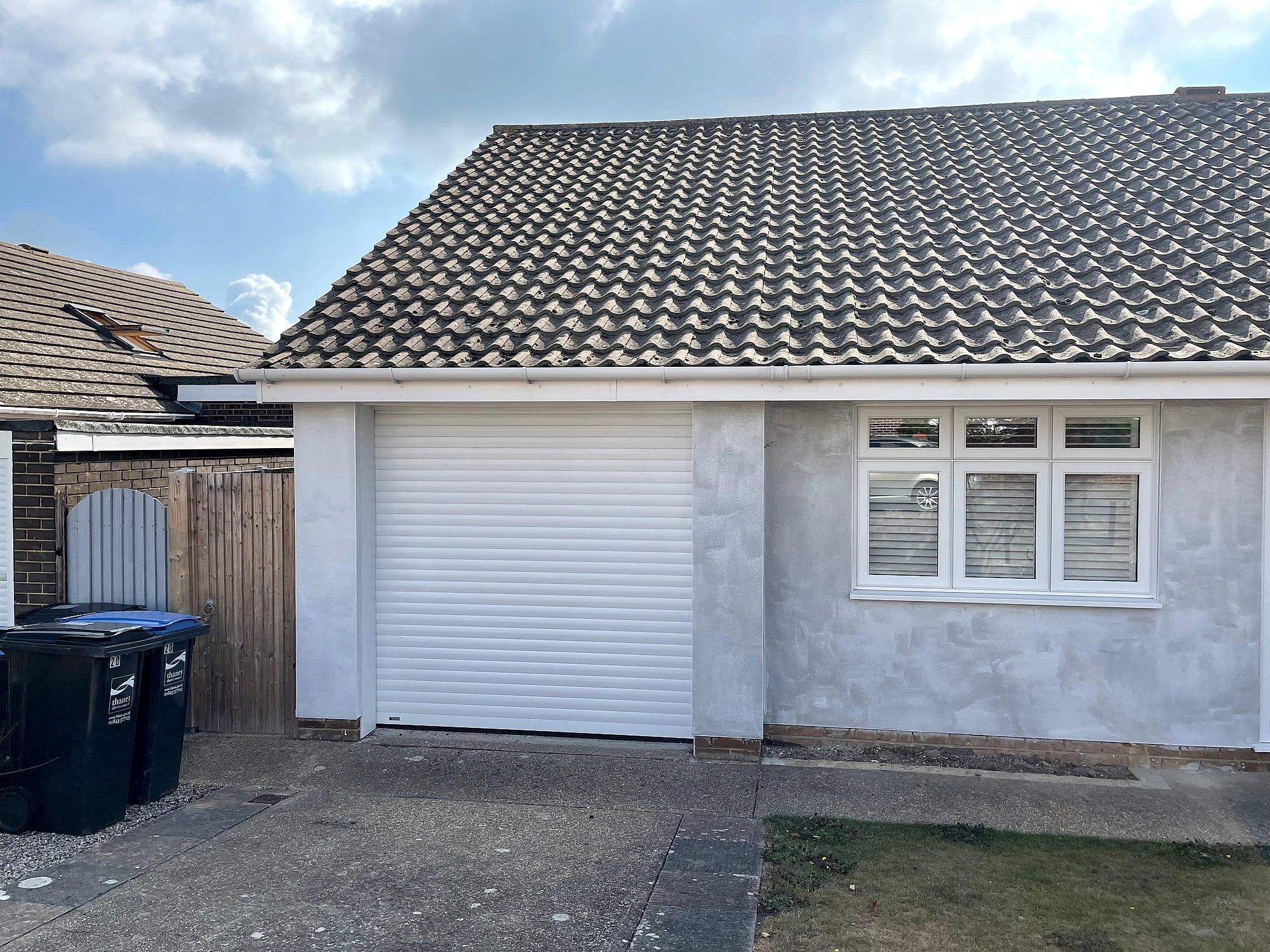 Bungalow garage exterior before rendering showing patchy old render needing replacement in East Kent