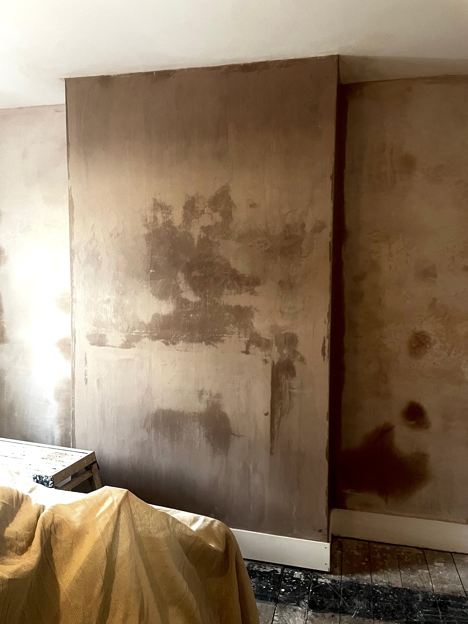 Chimney breast and walls being re-plastered with fresh skim coat and dust sheets in Kent period home