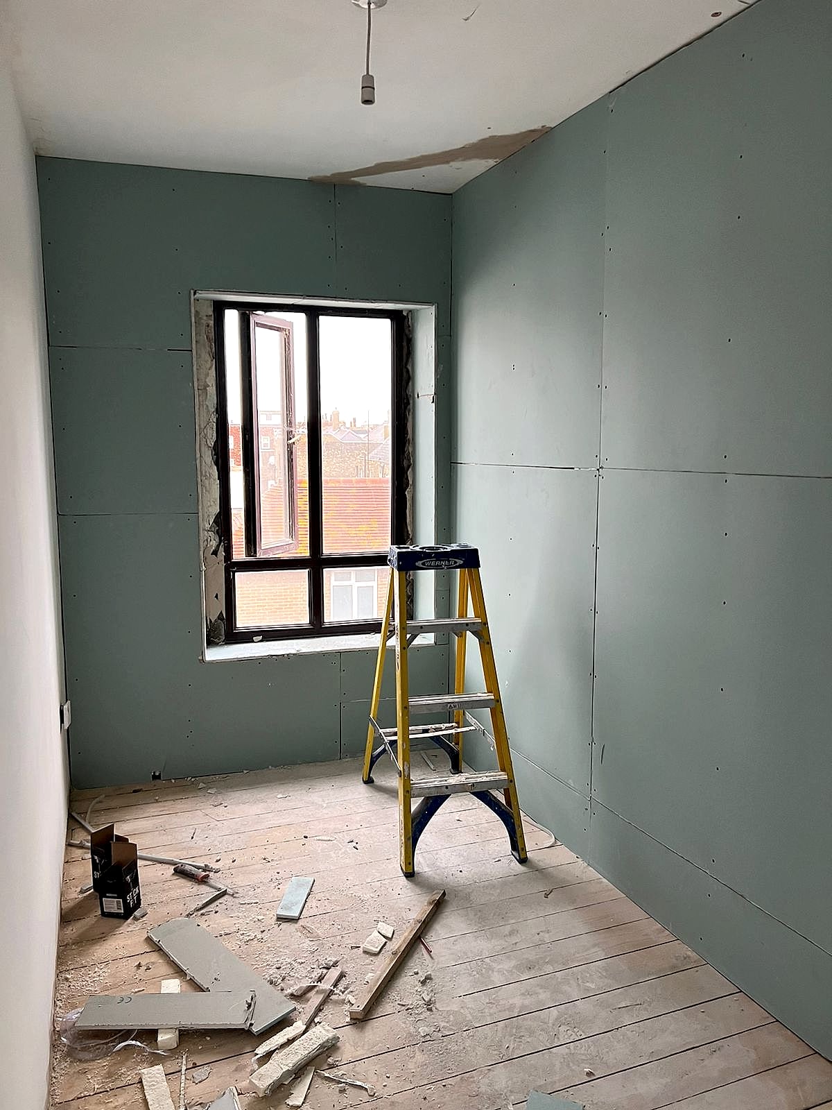 Room fully dry lined with moisture-resistant green plasterboard around windows in Broadstairs renovation