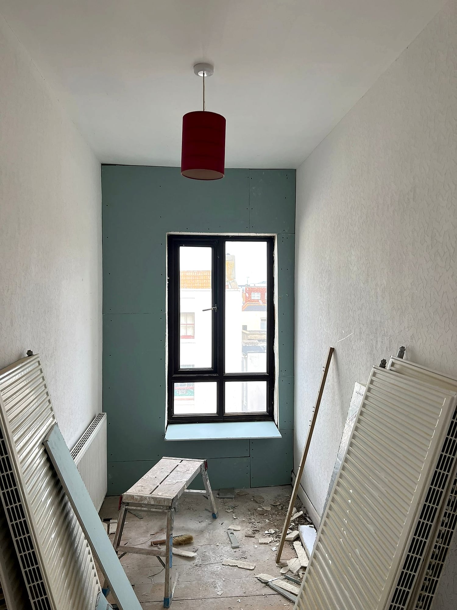 Moisture-resistant green plasterboard dry lining with window reveal in period property renovation in Broadstairs