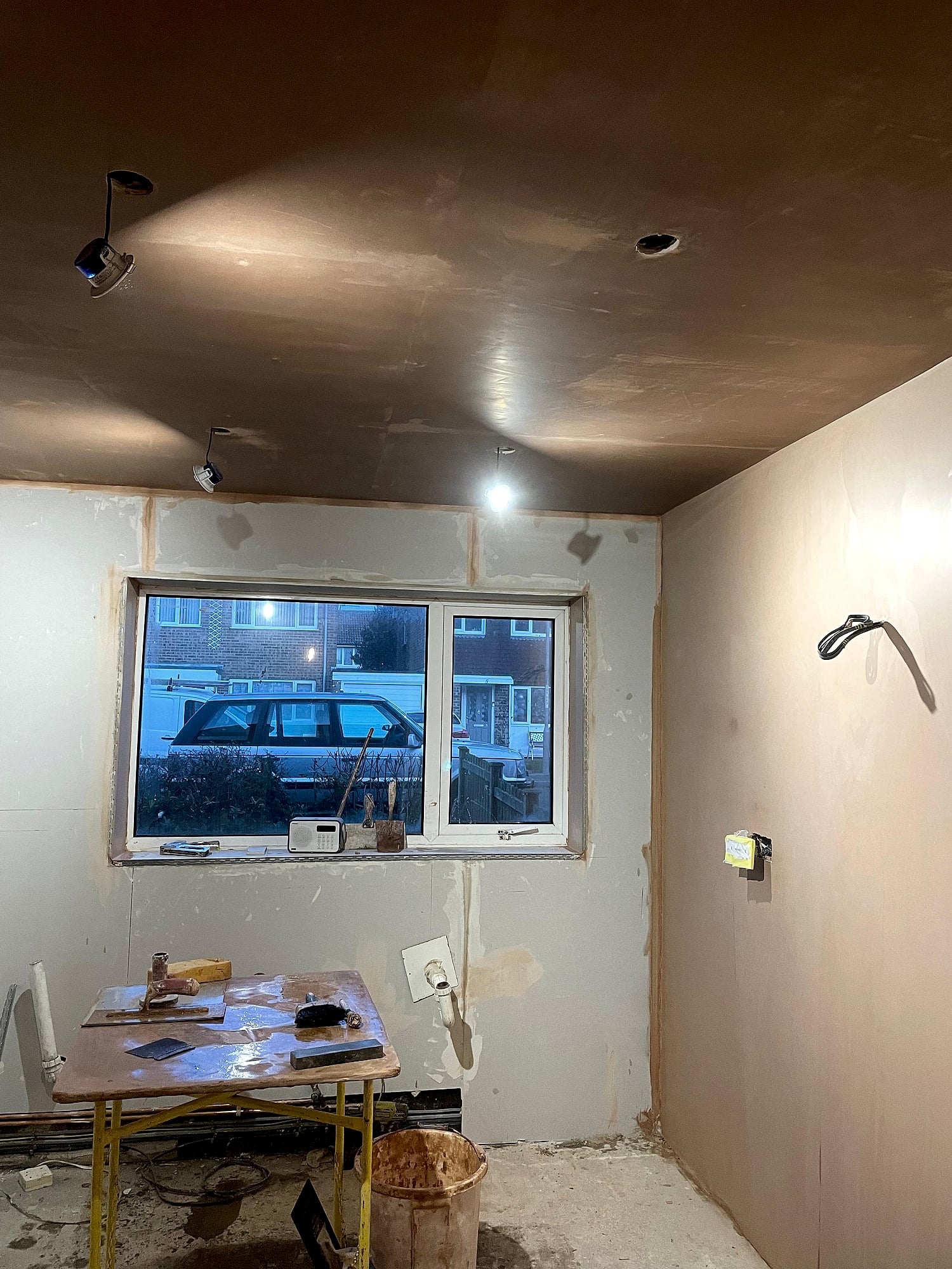 Garage conversion with freshly skimmed ceiling over plasterboard walls and recessed spotlights in Kent