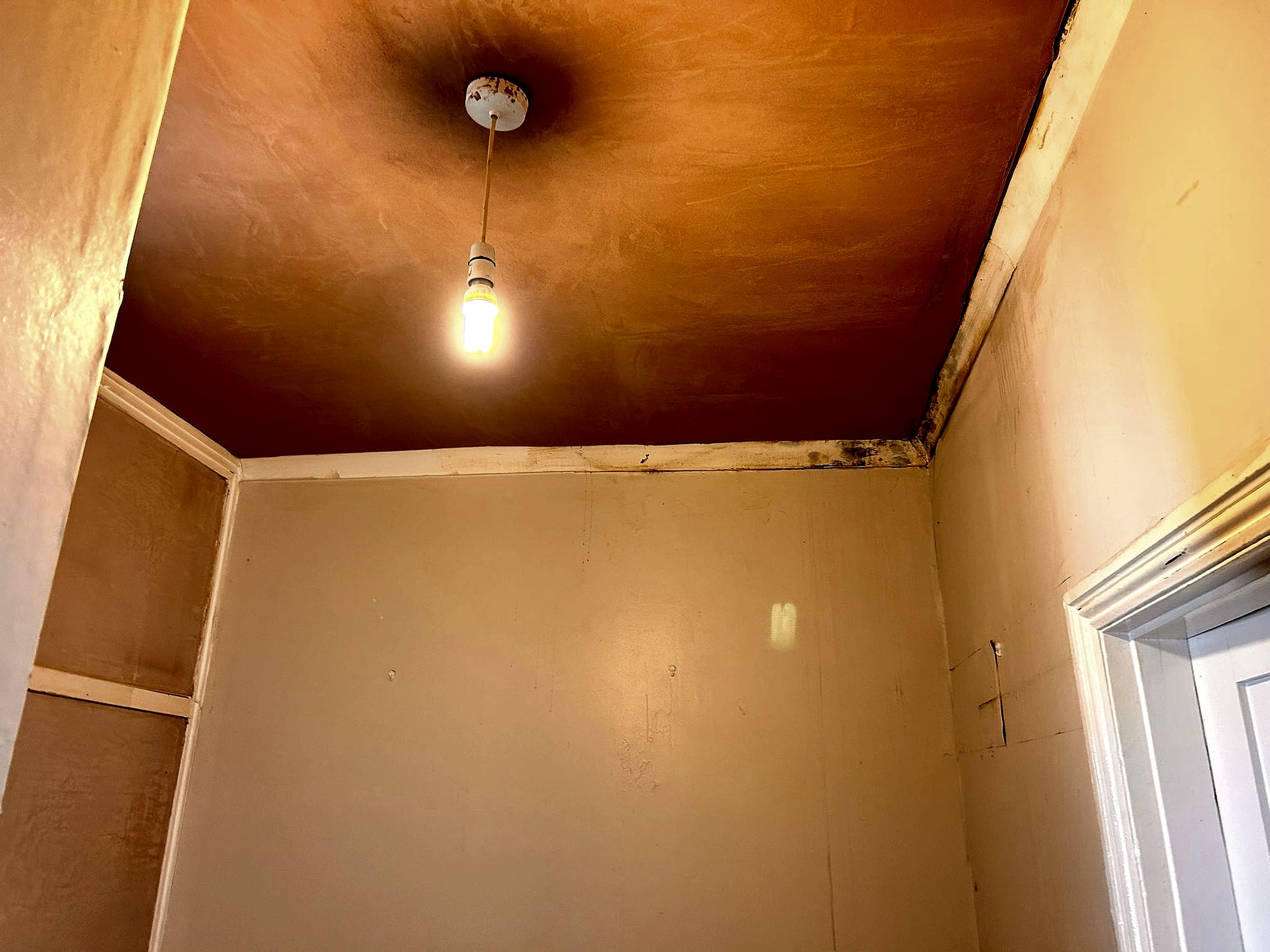 Hallway ceiling skim coat detail showing smooth plaster meeting existing walls in Kent home