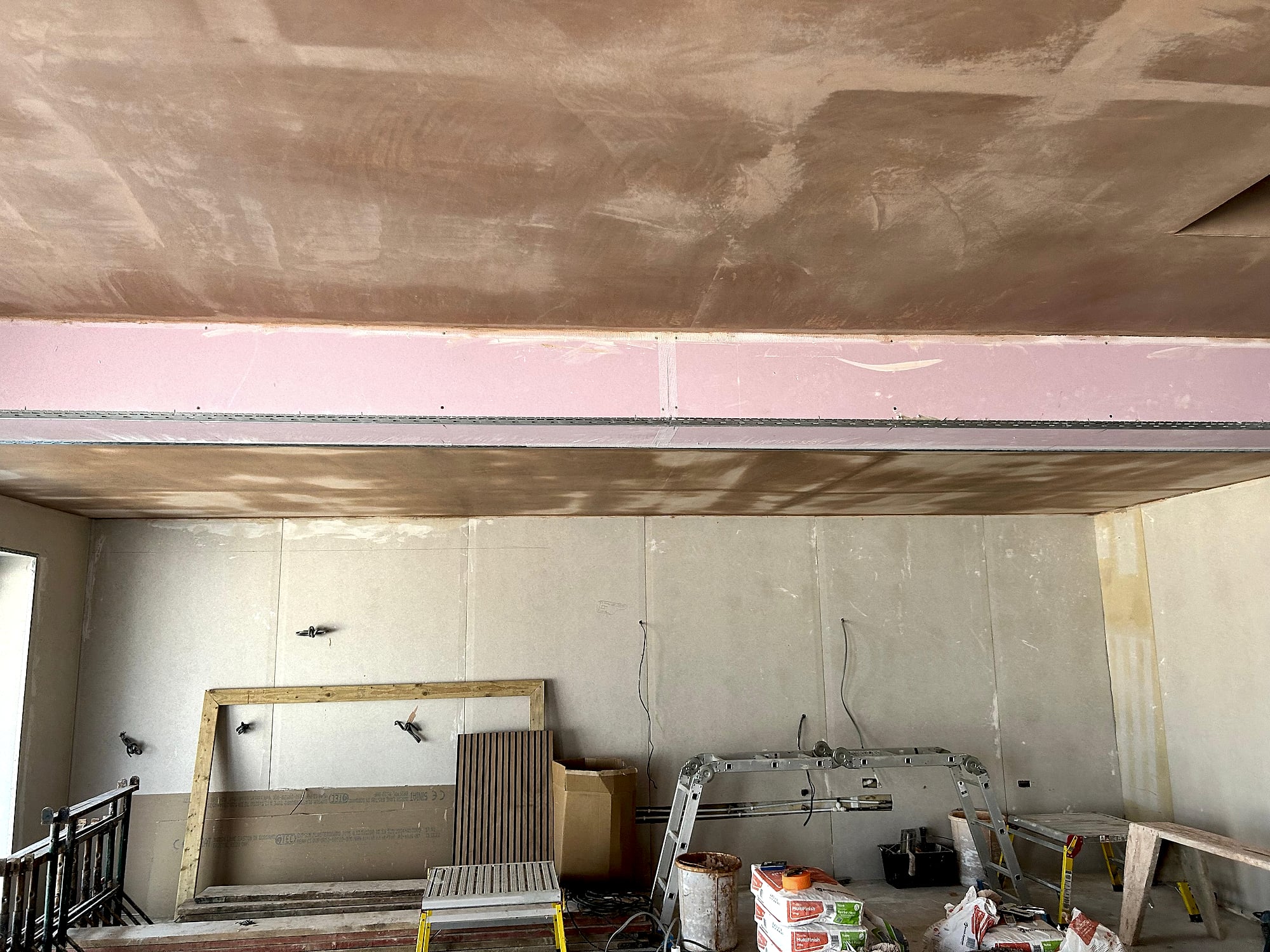 Hallway with freshly skimmed ceiling showing smooth plaster finish and pendant light fitting in Kent home