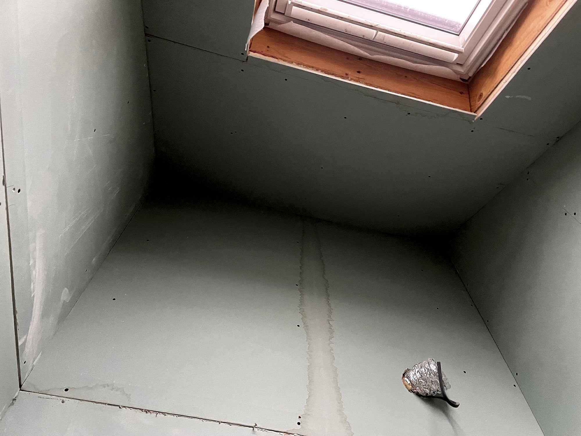 Loft bathroom dry lined with moisture-resistant green plasterboard around Velux skylight in Kent conversion