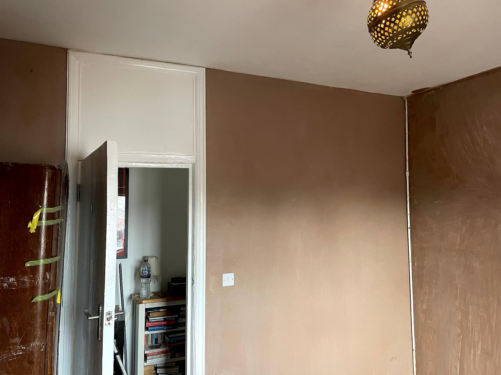 Freshly skimmed room walls with ornate Moroccan pendant light fitting showing smooth plaster finish in Kent