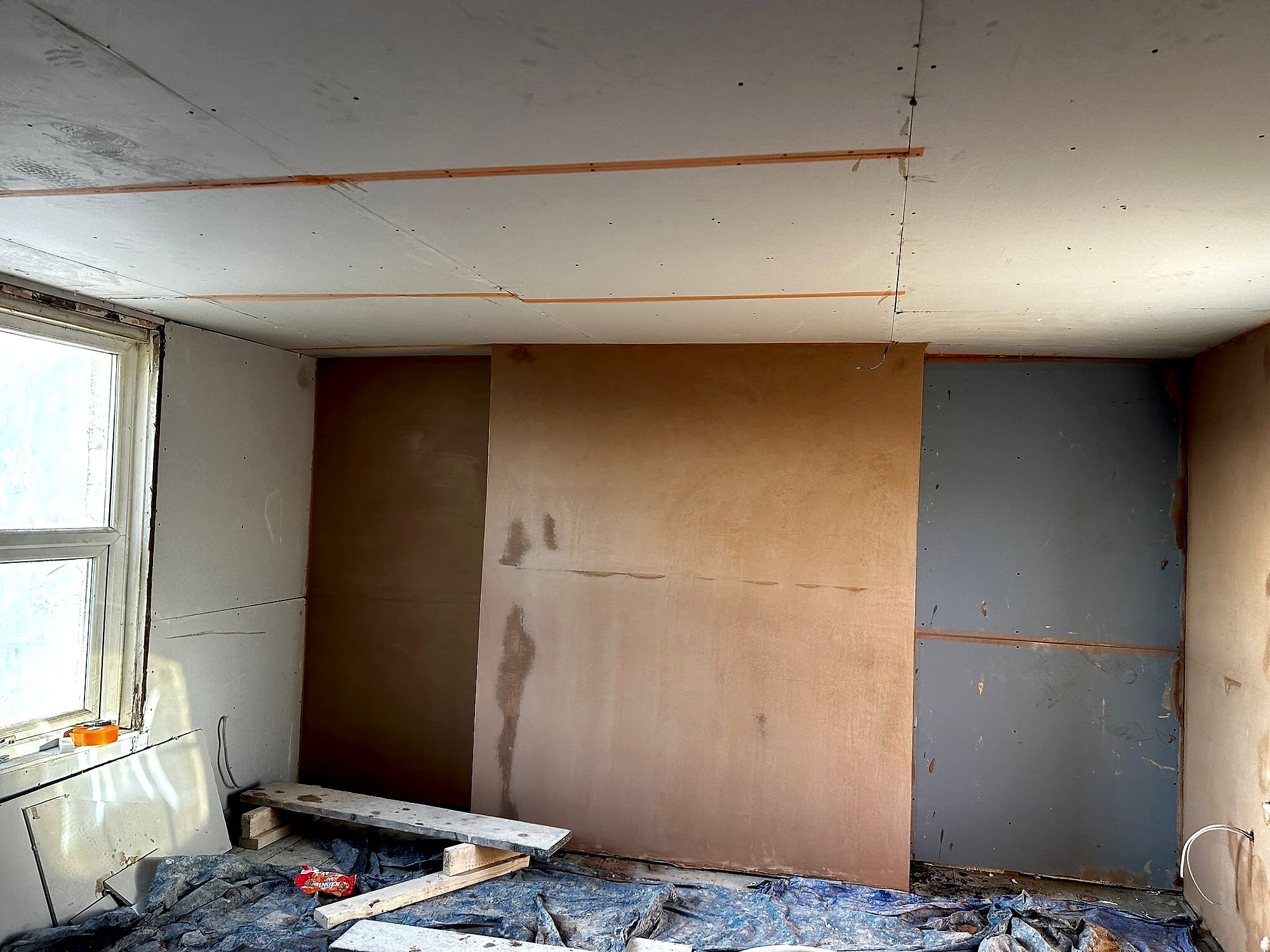 Room with freshly skimmed walls and taped plasterboard ceiling showing spotlights cutout in Kent property