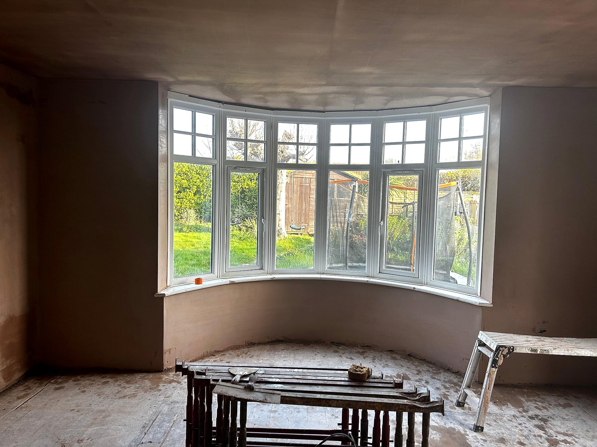 Victorian house with new plasterboard ceiling and walls being re-plastered around bay window in Kent