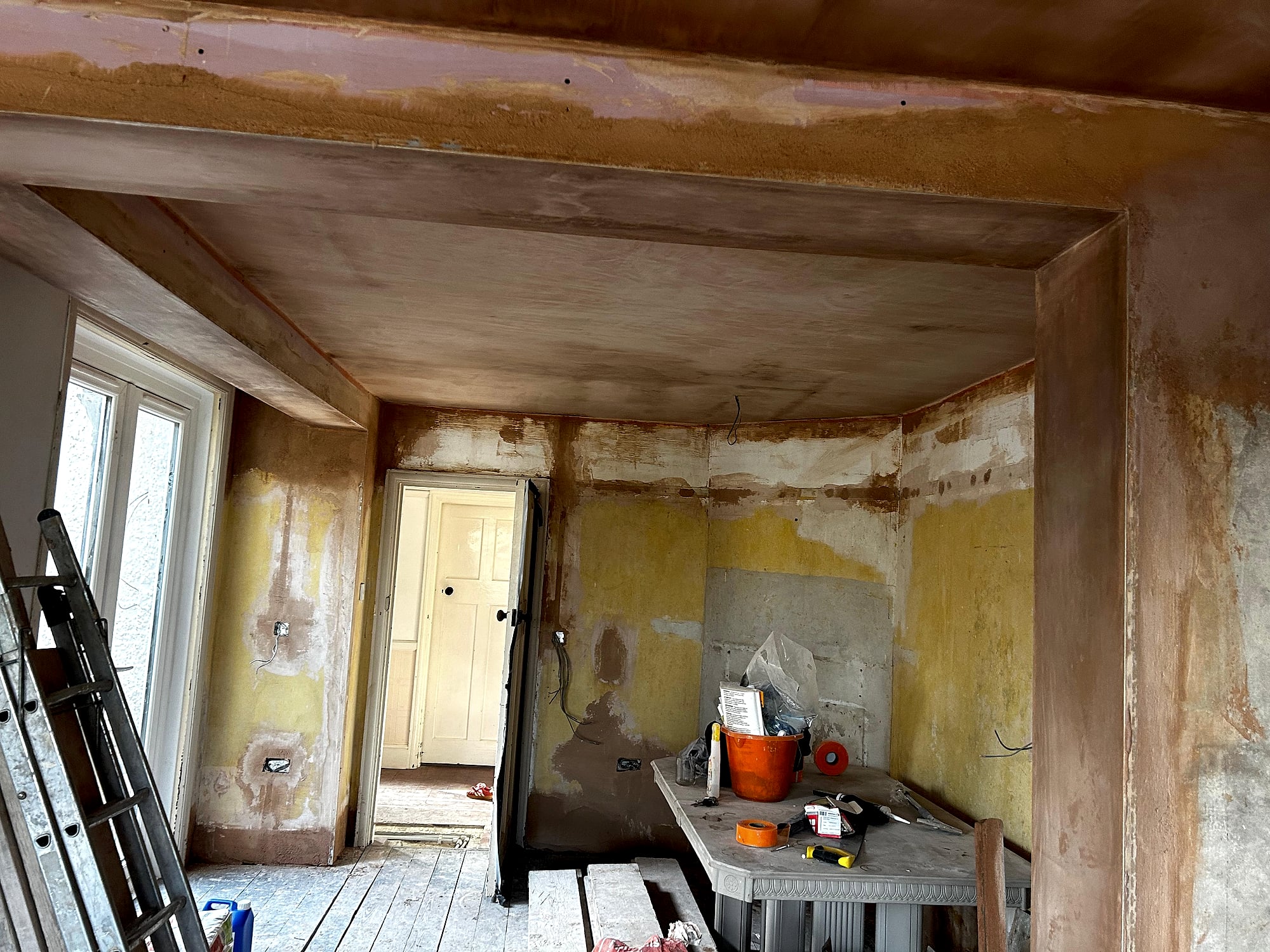 Victorian room with freshly plastered ceiling and beam detail showing partially completed skim in Kent